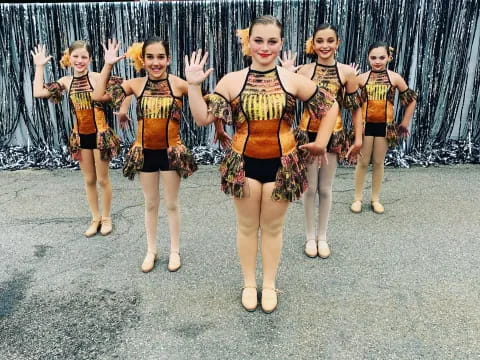 a group of girls in matching outfits