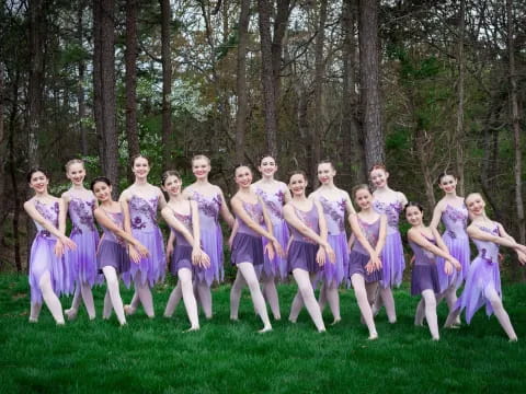 a group of people in purple dress posing in a forest