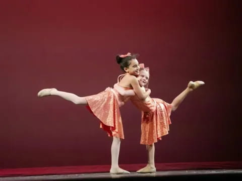 a couple of girls dancing on a stage