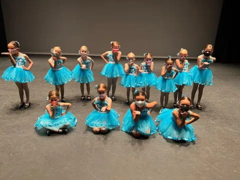 a group of girls in blue dresses