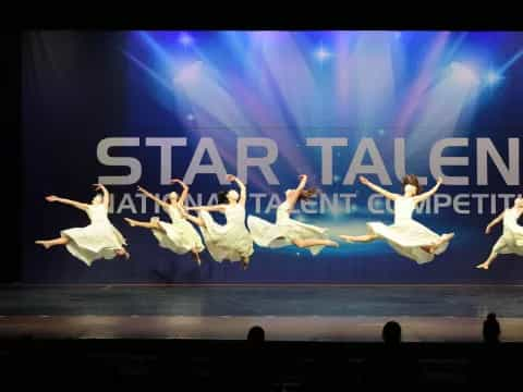 a group of people dancing on a stage