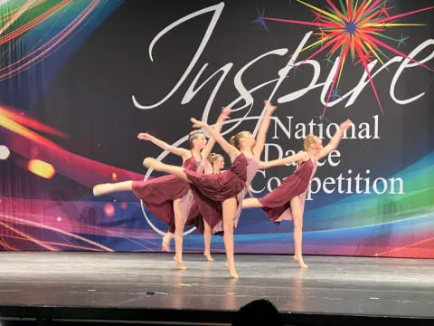 a group of women dancing on a stage