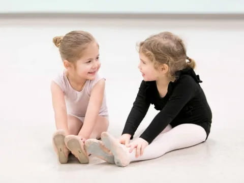 a woman and a child sitting on the ground