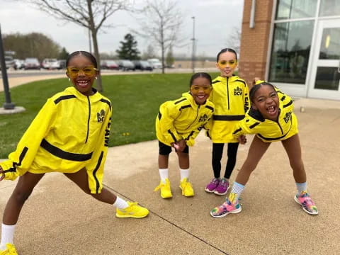a group of kids wearing yellow uniforms