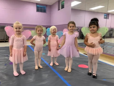 a group of girls in dresses