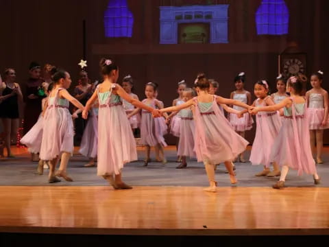 a group of girls dancing on a stage