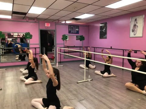 a group of women exercising in a gym