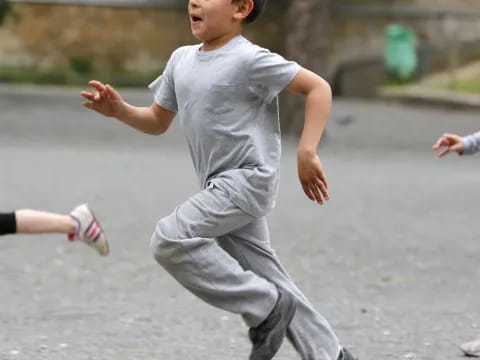 a boy running on a road