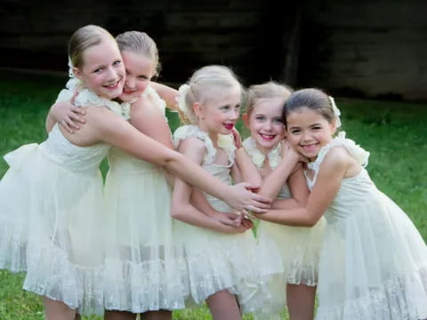 a group of girls in dresses