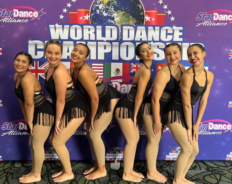 a group of women in swimsuits posing for a picture