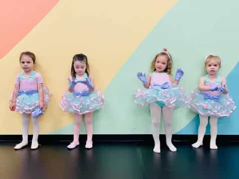 a group of girls in dresses