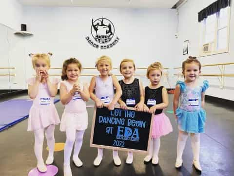 a group of girls holding a sign