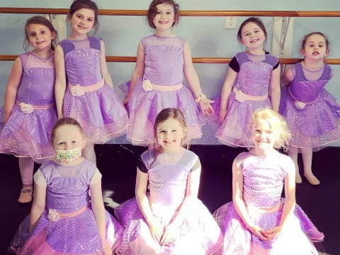 a group of girls in dresses