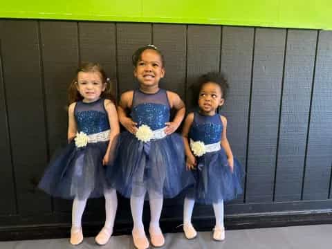 a group of girls in blue dresses