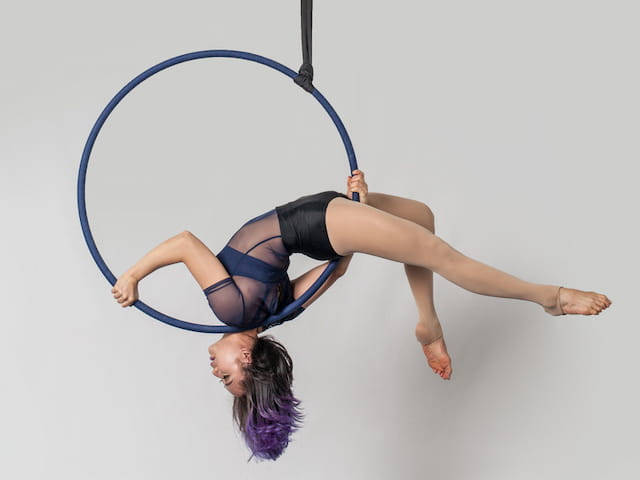 a person in a blue leotard doing a handstand