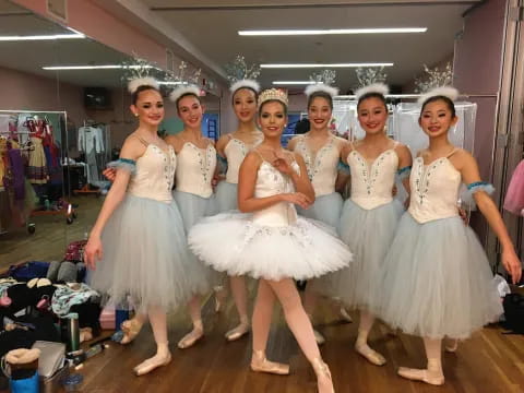 a group of women in white dresses