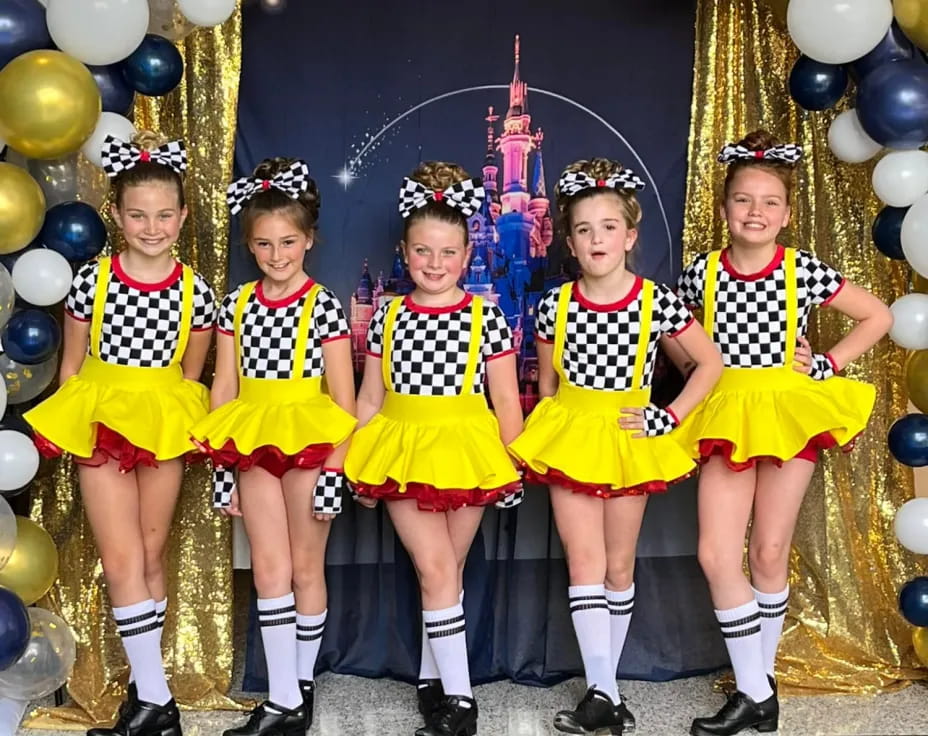 a group of girls in yellow uniforms