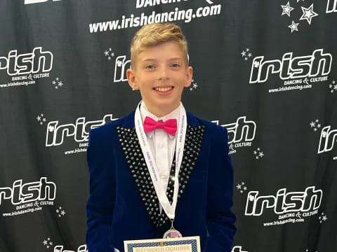 a boy holding a certificate