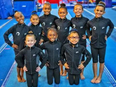 a group of children in black and white uniforms