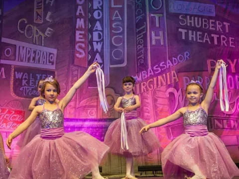 a group of girls in dresses dancing