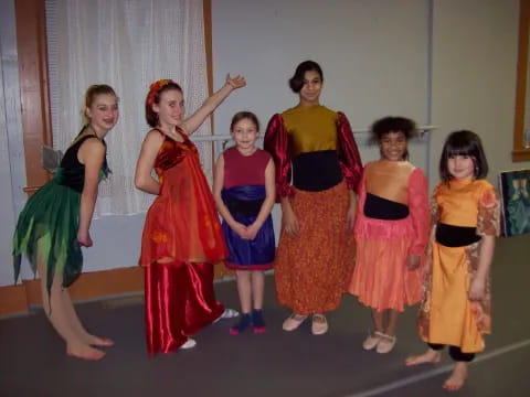 a group of girls in dresses