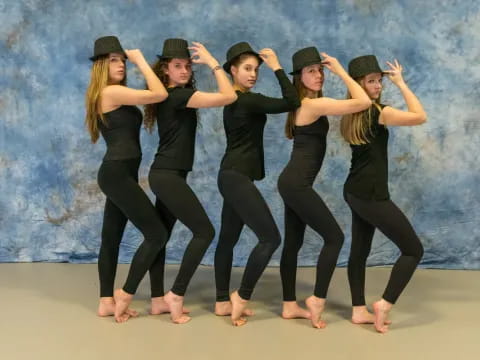 a group of women in black pants