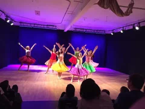 a group of people dancing on a stage