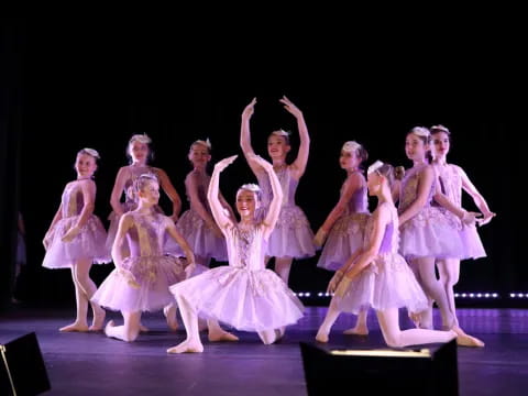 a group of women in dresses on a stage