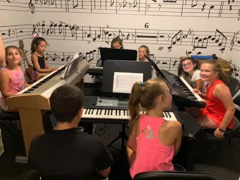 a group of people playing piano