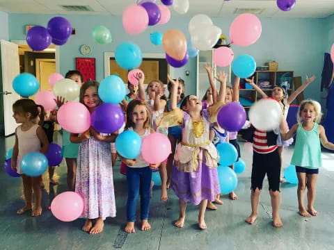 a group of people holding balloons