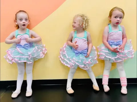 a group of girls in dresses