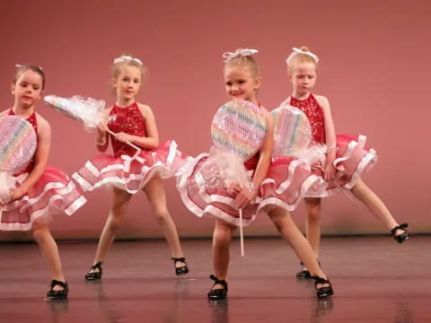 a group of women in dresses dancing