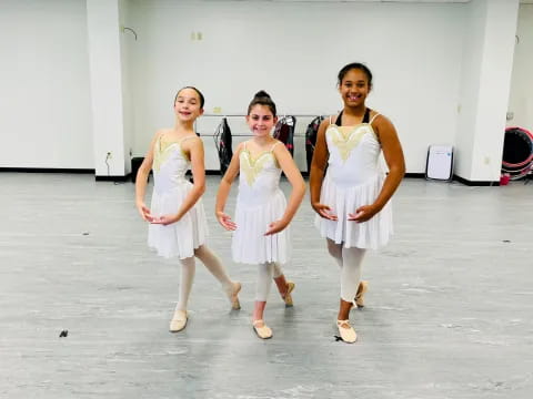 a group of women in white dresses