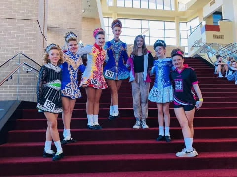 a group of cheerleaders posing on a red carpet