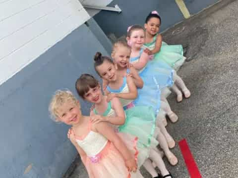 a group of girls in dresses