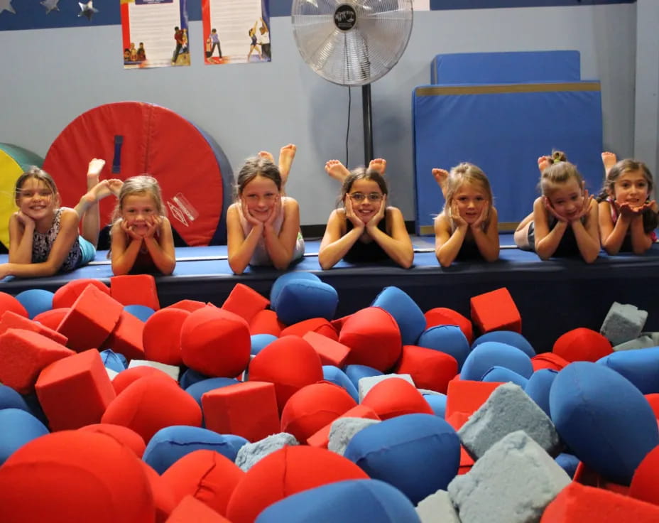 a group of women sitting in a large ball pit