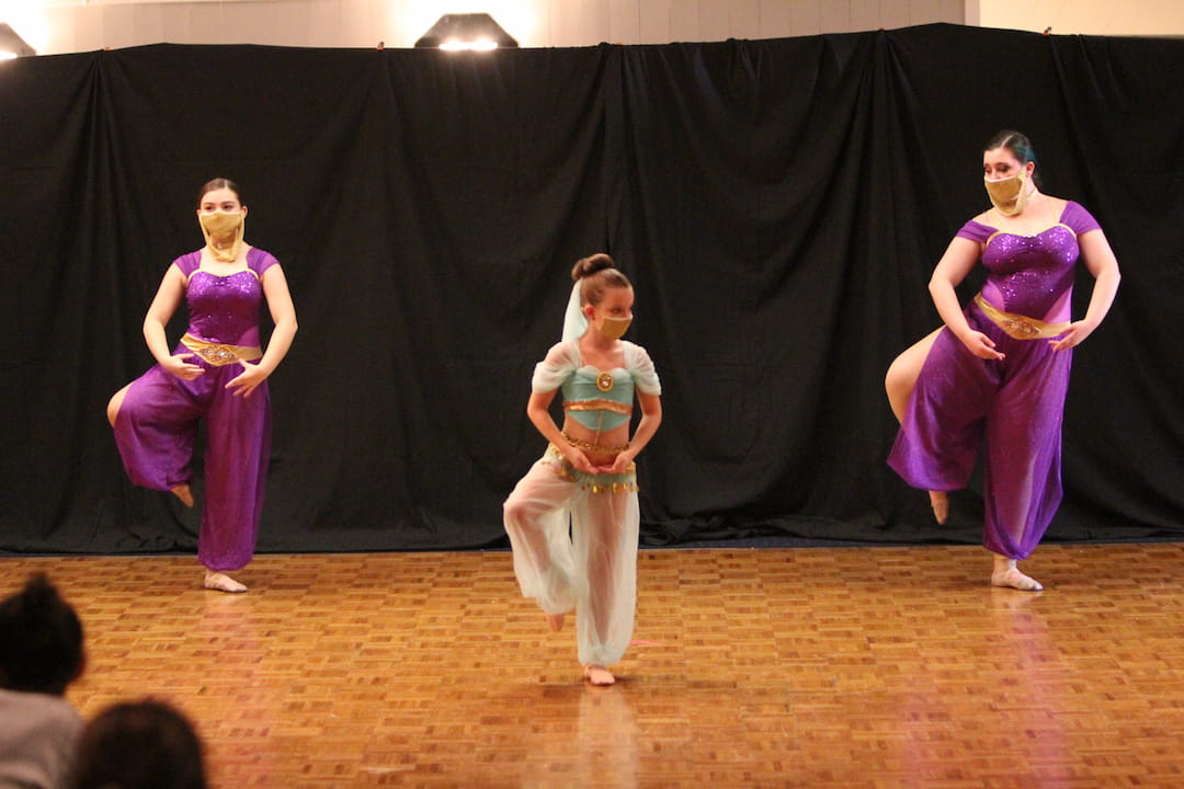 a group of women dancing on a stage