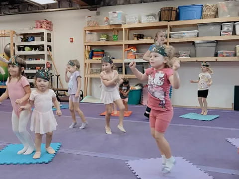 a group of children exercising in a gym