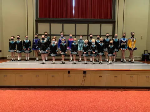 a group of people in sports uniforms standing on a podium