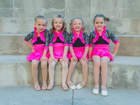 a group of girls in matching outfits