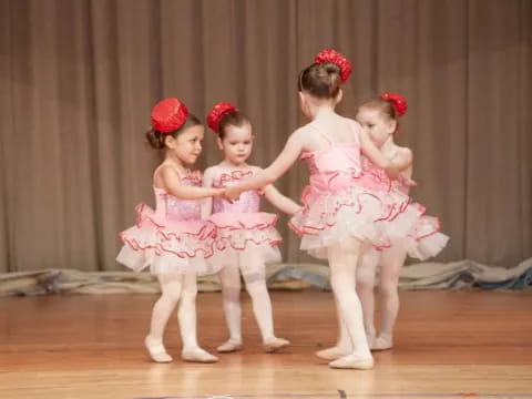a group of girls in dresses and skirts on a stage