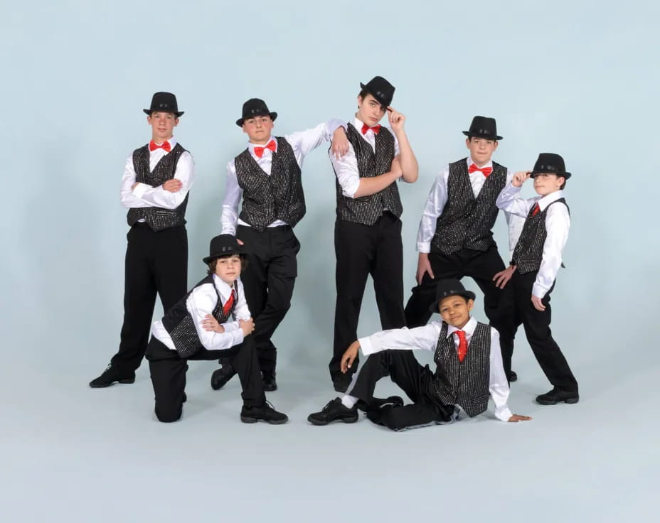 a group of men in black and white clothes posing for a photo