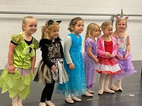 a group of children in dresses