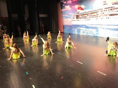 a group of children dancing on a stage