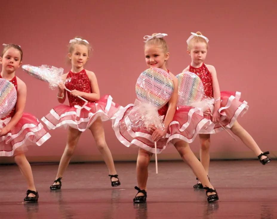 a group of women in dresses dancing