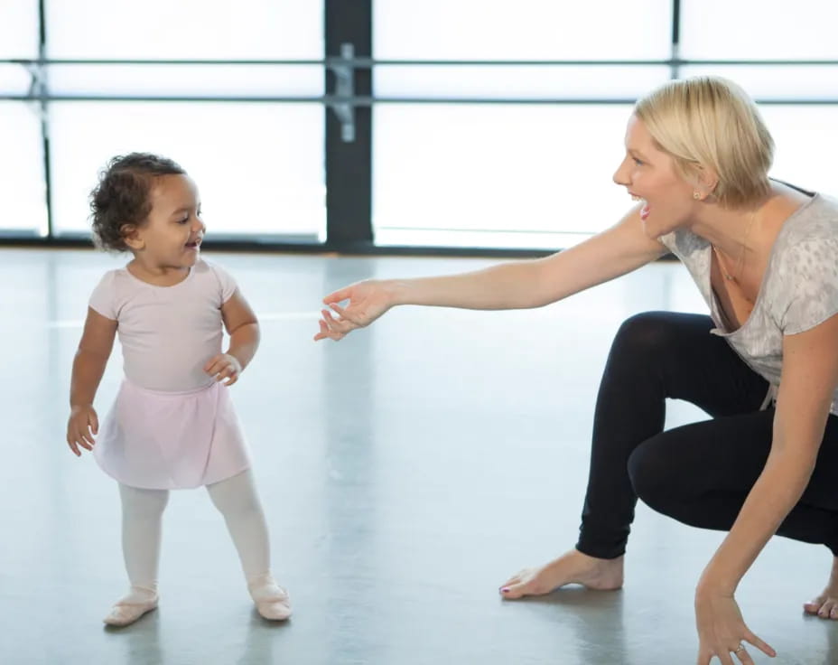 a person and a child dancing