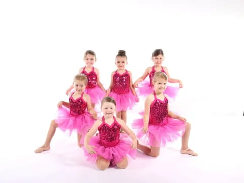 a group of girls in dresses