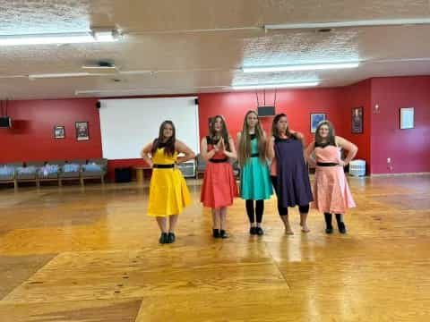 a group of women in dresses