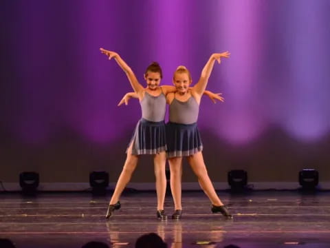 a couple of women dancing on a stage