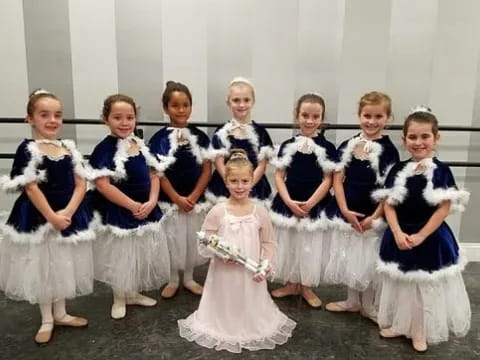 a group of girls in dresses